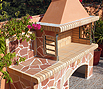 CODE 6: Barbeque with firebrick, coated with irregular, pink, Brazilian slab, 130 x 80 cm and bench coated with irregular Brazilian slab, 75 x 80 cm