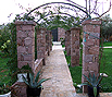 CODE 9: Pergola construction, with builders, stone columns from Mytilini burgundy stones, and floor configuration, with old demolition bricks